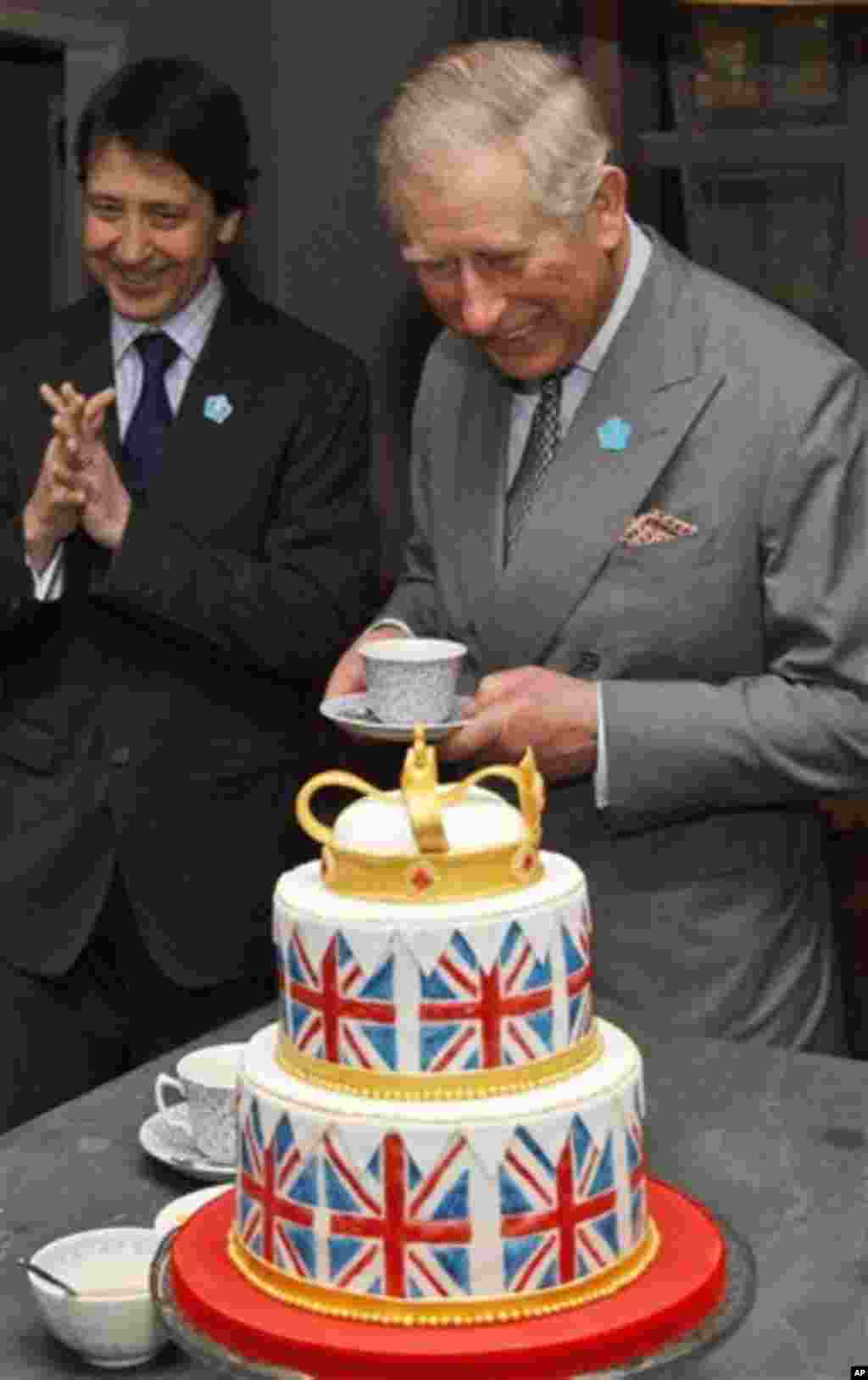 Britain's Prince Charles, right, partakes in a cup of tea during his visit at the Ideal Home Show, in London, Friday, March 16, 2012. The Prince, who visited the show last year, will formally open the 17 day event, which is now in its 104th year and attr