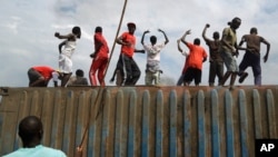 Demonstrators climb on a container they moved to use as a barricade in the Cibitoke neighborhood of Bujumbura, Burundi, May 19, 2015.