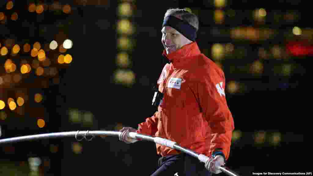 Nik Wallenda walks over the Chicago River uphill nearly 8 stories for Discovery Channel's Skyscraper Live with Nik Wallenda, Nov. 2, 2014. 