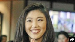 Thailand's new Prime Minister Yingluck Shinawatra gives a Thai traditional "wai" greeting at parliament in Bangkok, Aug. 5, 2011