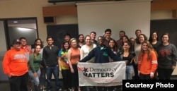 Political science student Cassie Cleary stands in the middle of a group of her fellow members of Syracuse University's chapter of Democracy Matters.