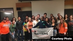 Political science student Cassie Cleary stands in the middle of a group of her fellow members of Syracuse University's chapter of Democracy Matters.