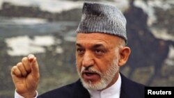 Afghan President Hamid Karzai speaks during a news conference in Kabul, June 12, 2012. 