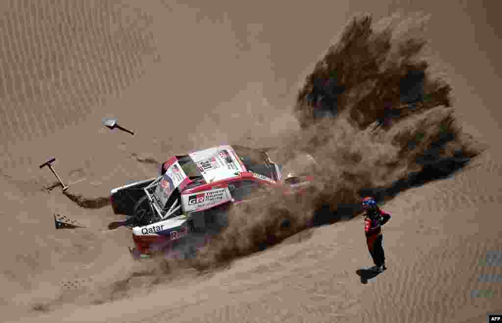 페루 산후안 더 마르코나 지역에서 열린 2018 다카르 자동차 경주대회에서 토요타 팀으로 출전한 카타르의 나세르 알-아티야흐 선수와 프랑스의 마티유 바우멜 선수사가 모래 언덕에 빠진 차를 빼내기 위해 애쓰고 있다.