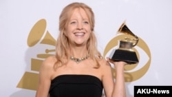 FILE - Maria Schneider poses in the press room with the award for best contemporary classical composition for "Schneider, Maria: Winter Morning Walks" at the 56th annual Grammy Awards at Staples Center, Jan. 26, 2014, in Los Angeles. 