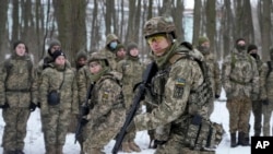 Members of Ukraine's Territorial Defense Forces, volunteer military units of the Armed Forces, train in a city park in Kyiv, Ukraine, Jan. 22, 2022. Dozens of civilians have been joining Ukraine's army reserves in recent weeks amid fears of a Russian inva