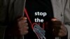 FILE- A man shows the logo of a T-shirt that reads "Stop the Cut" referring to Female Genital Mutilation (FGM) in Imbirikani, Kenya, April 21, 2016. 