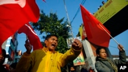 Members of the splinter faction of the Unified Communist Party of Nepal Maoist shout slogans during a general strike called by the party against the decision to form an interim government in Katmandu, Nepal, February 19, 2013.