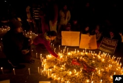 FILE - Indians light candles as they mourn the death of a gang rape victim in New Delhi, India, Dec. 30, 2012.
