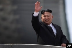 North Korean leader Kim Jong Un waves during a military parade, April 15, 2017, in Pyongyang, North Korea to celebrate the 105th birth anniversary of Kim Il Sung, the country's late founder and grandfather of current ruler Kim Jong Un.