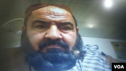 Handout photo showing Mullah Mansur at Pakistan's Federal Investigation Agency (FIA) immigration office on the Pakistan-Iran-Afghan border. He passed through the usual entry/exit booth in front of a computer, five hours before his killing.