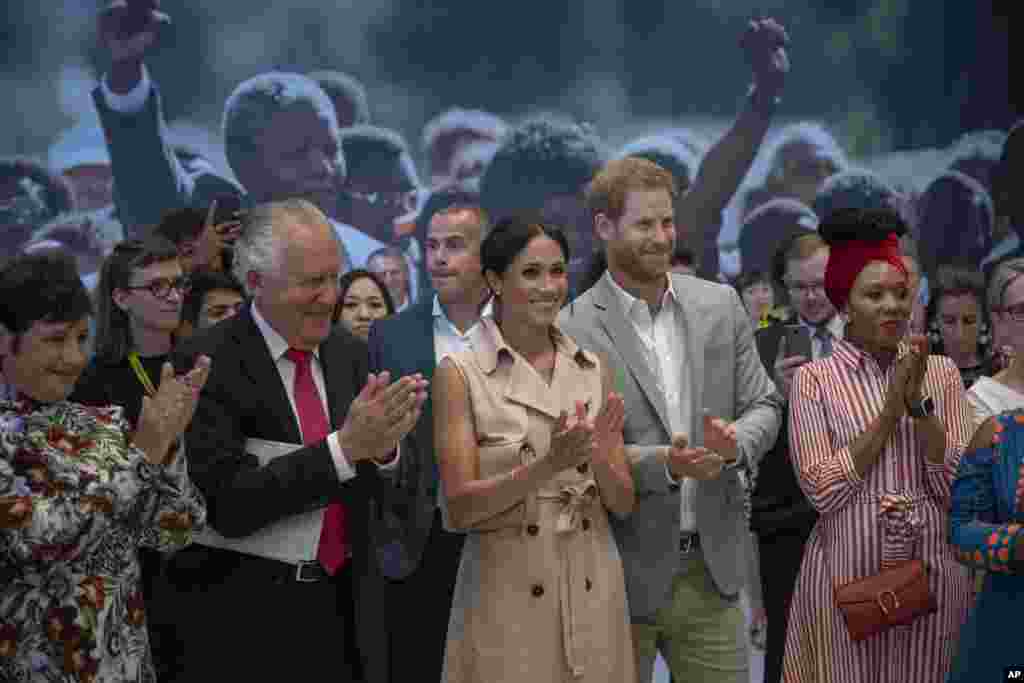 Britain&#39;s Prince Harry, second right, and Meghan, the Duchess of Sussex, attend the launch of the Nelson Mandela Centenary Exhibition, marking the 100th anniversary of the anti-apartheid leader&#39;s birth, at the Queen Elizabeth Hall in London.