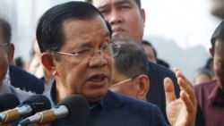 Cambodia's Prime Minister Hun Sen delivers a speech to passengers after they disembarked from the MS Westerdam, owned by Holland America Line, at the port of Sihanoukville, Cambodia, Friday, Feb. 14, 2020. (AP photo)