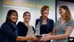 In this April 15, 2016 photo, reporters for the Associated Press Esther Htusan, Margie Mason, Robin McDowell and Martha Mendoza receive the Selden Ring Award for Investigative Reporting at USC Annenberg in Los Angeles. The team won the Pulitzer Prize for public service for articles documenting the use of slave labor in the commercial seafood industry in Indonesia and Thailand announced Monday, April 18, 2016. (AP Photo/Richard Vogel)