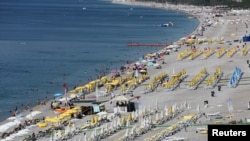 Tourists enjoy a beach in the Mediterranean resort city of Antalya, a popular destination for German tourists, in Turkey, July 25, 2016.