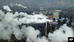 In this Nov. 28, 2019, file photo, smoke and steam rise from a coal processing plant in Hejin in central China's Shanxi Province. (AP/Sam McNeil)