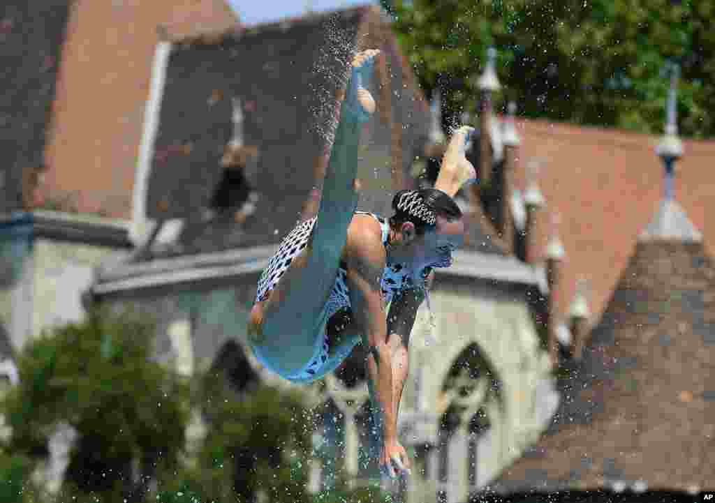 A member of the Ukraine team performs during the women's team free synchronized swimming final free routine of the 17th FINA World Championships in the City Park venue, in Budapest, Hungary.