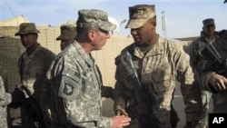 Gen. David Petraeus, left, top U.S. and NATO commander in Afghanistan, meets US Marines during his visit to Marjah, Afghanistan, 25 Dec 2010