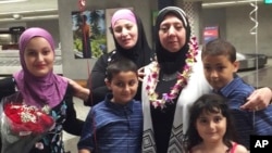 A Syrian woman who is a plaintiff in Hawaii's challenge to the travel ban ordered by the Trump administration greets her mother-in-law after she arrived from Syria at Honolulu's Daniel K. Inouye International Airport on Aug. 12, 2017.