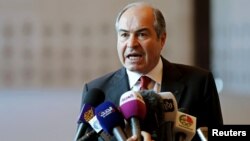 FILE - Jordan's Prime Minister Hani Mulki speaks to the media after the swearing-in ceremony for the new cabinet at the Royal Palace in Amman, Jordan, June 1, 2016.