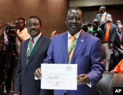 Orange Democratic Party presidential candidate, Raila Odinga (R), displays his registration certificate, with running mate Vice President Kalonzo Musyoka (L), in Nairobi, Kenya, Jan. 30. 2013.