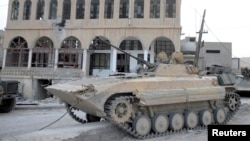 A tank belonging to the forces of Syria's President Bashar al-Assad is seen at Al-Sahl town, about 2km (a mile) to Yabroud's north, after the soldiers took control of it from the rebel fighters, March 3, 2014.