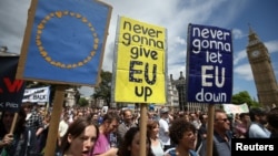 Protestors hold banners in Parliament Square during a 'March for Europe' demonstration against Britain's decision to leave the European Union, central London, Britain, July 2, 2016. 