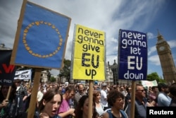 Protestors hold banners in Parliament Square during a 'March for Europe' demonstration against Britain's decision to leave the European Union, central London, Britain, July 2, 2016.