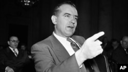 FILE - Sen. Joseph McCarthy gestures during a Senate subcommittee hearing in Washington on McCarthy's charges of communist infiltration of the U.S. State Department, March 9, 1950.