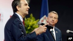 Democratic candidate for governor, Lt. Gov. Ralph Northam, left, gestures during a debate with Republican challenger Ed Gillespie at the University of Virginia-Wise in Wise, Va., Oct. 9, 2017. 