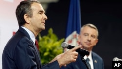 Democratic candidate for governor, Lt. Gov. Ralph Northam, left, gestures during a debate with Republican challenger Ed Gillespie at the University of Virginia-Wise in Wise, Va., Oct. 9, 2017.