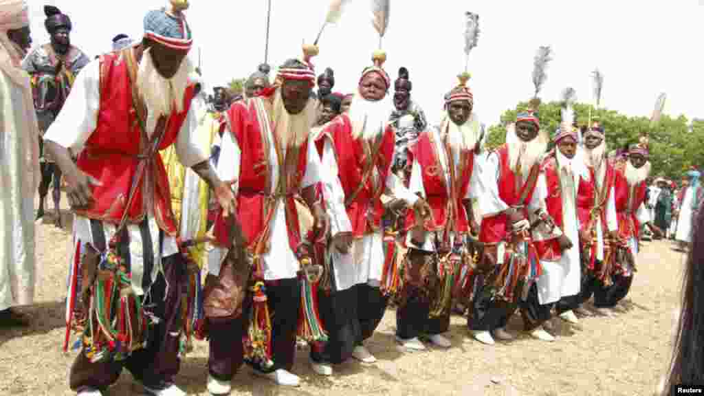 Traditional dancers take part in a parade as they pay homage to Emir of Kano Alhaji Ado Bayero during an event marking his 50th year on the throne.