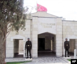 FILE - Turkish soldiers stand guard at the entrance to the memorial site of Suleyman Shah, grandfather of Osman I, founder of the Ottoman Empire, in Karakozak village, northeast of Aleppo, Syria, April 2011.