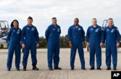 At NASA's Kennedy Space Center in Florida, space shuttle Discovery's STS-133 crew on the Shuttle Landing Facility runway.