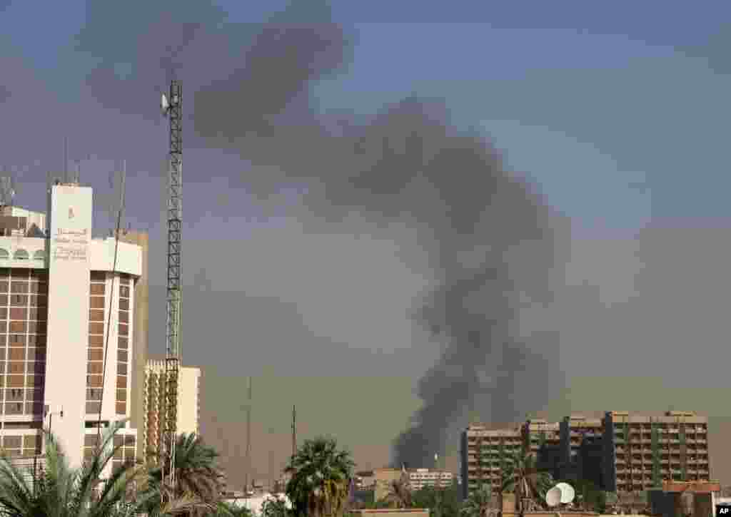 Smoke rises after a car bomb attack in front of the Ministry of Higher Education and Scientific Research in central Baghdad, Sept. 18, 2013. 