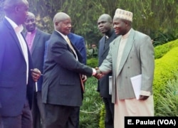 President Yoweri Museveni arrives at the debate hall in Kampala, Feb. 16, 2016, greeted by the Inter-Religious Council of Uganda.