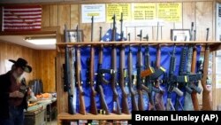 In this March 15, 2016 photo, guns for rent are on display at a shooting range and retail store in Cherry Creek, Colorado.