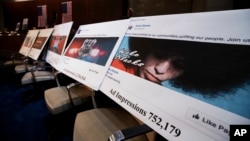 FILE - Facebook ads linked to a Russian effort to disrupt the American political process are displayed as Google, Facebook and Twitter officials testify during a House Intelligence Committee hearing on Capitol Hill in Washington, Nov. 1, 2017. Now Britain is threatening Facebook and Twitter with consequences over Russia's use of the platforms in the run-up to last year's Brexit referendum.