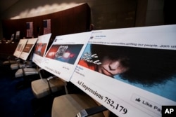 FILE - Facebook ads linked to a Russian effort to disrupt the American political process are displayed as Google, Facebook and Twitter officials testify during a House Intelligence Committee hearing on Capitol Hill in Washington, Nov. 1, 2017.