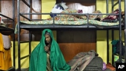 A homeless woman rests inside a shelter for homeless women and children managed by a non-governmental organization in New Delhi, January 6, 2011