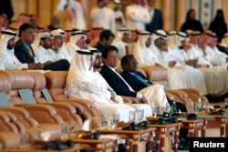 FILE - Pakistani Prime Minister Imran Khan, surrounded by host country representatives and other participants, attends an investment conference in Riyadh, Saudi Arabia, Oct. 23, 2018.