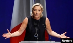 French far-right National Rally (Rassemblement National) party leader Marine Le Pen delivers her comeback speech in Frejus, France, Sept. 16, 2018. The backdrop reads "Nations will save Europe."