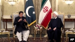 In this photo released by the official website of the office of the Iranian Presidency, Pakistani Prime Minister Imran Khan, left, talks with Iranian President Hassan Rouhani during their meeting at the Saadabad Palace, in Tehran, Iran, April 22, 2019.