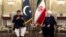 In this photo released by the official website of the office of the Iranian Presidency, Pakistani Prime Minister Imran Khan, left, talks with Iranian President Hassan Rouhani during their meeting at the Saadabad Palace, in Tehran, Iran, April 22, 2019.