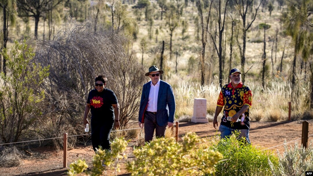 Australian Prime Minister Anthony Albanese, center, walks to a meeting with Indigenous leaders from central Australia in the Uluru Kata Tjuta National Park in central Australia on Oct. 10, 2023.