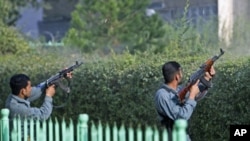 Afghan policemen fire toward a building that the Taliban insurgents took over during an attack near the U.S. embassy in Kabul, Afghanistan, September 13, 2011.