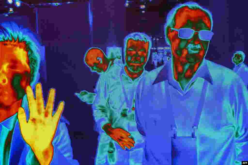 People are captured by FLIR (Forward-Looking Infrared) HD Thermal Imaging Cameras as they walk near the FLIR show at the Las Vegas Convention Center during CES 2019, Jan. 10, 2019.