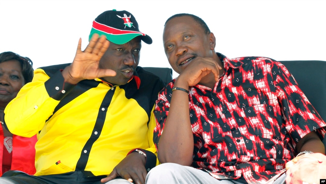 The National Alliance Party presidential candidate Deputy Prime Minister Uhuru Kenyatta right, and his running mate William Ruto, talk during a rally at Uhuru Park, in Nairobi, January 12, 2013. 