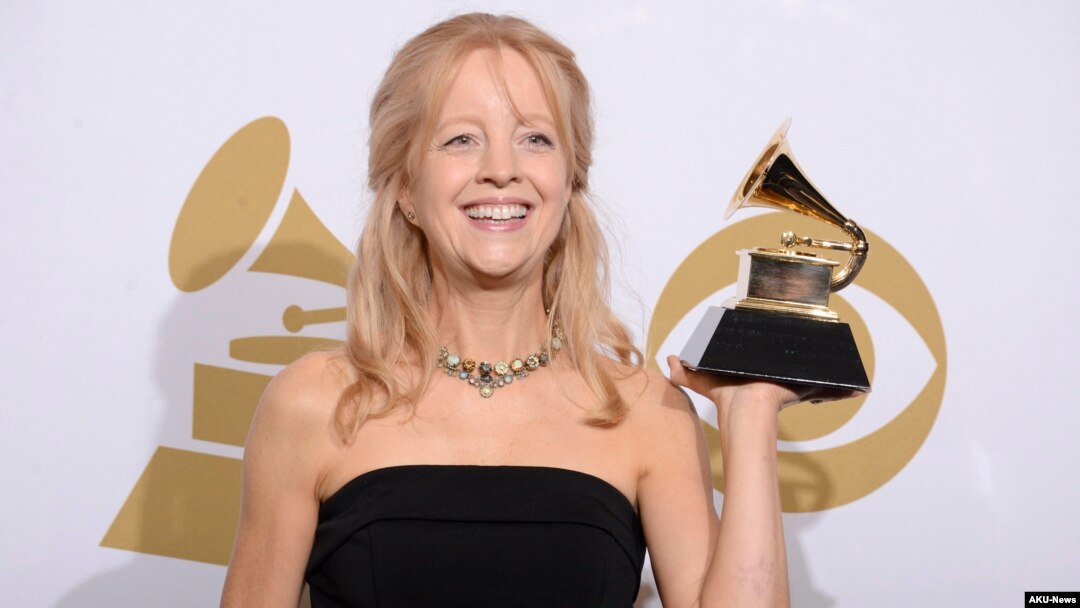 FILE - Maria Schneider poses in the press room with the award for best contemporary classical composition for "Schneider, Maria: Winter Morning Walks" at the 56th annual Grammy Awards at Staples Center, Jan. 26, 2014, in Los Angeles. 