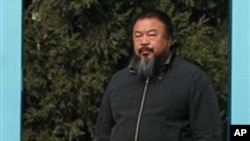 Chinese avant-garde artist Ai Weiwei stands at the doorway to his home where he is under house arrest in Beijing Saturday, Nov. 6, 2010.